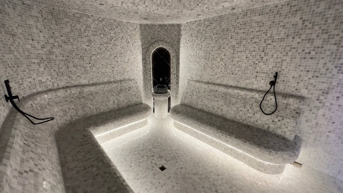 Luxurious steam room with mosaic tiles and ambient lighting