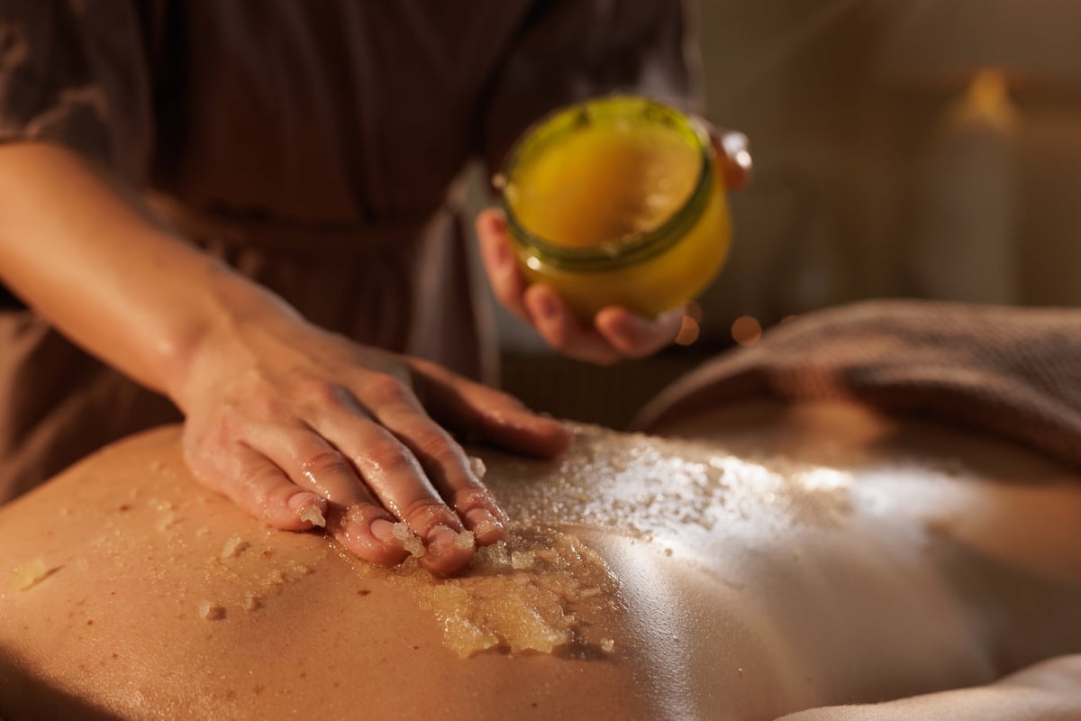 Body scrub exfoliation treatment during spa session