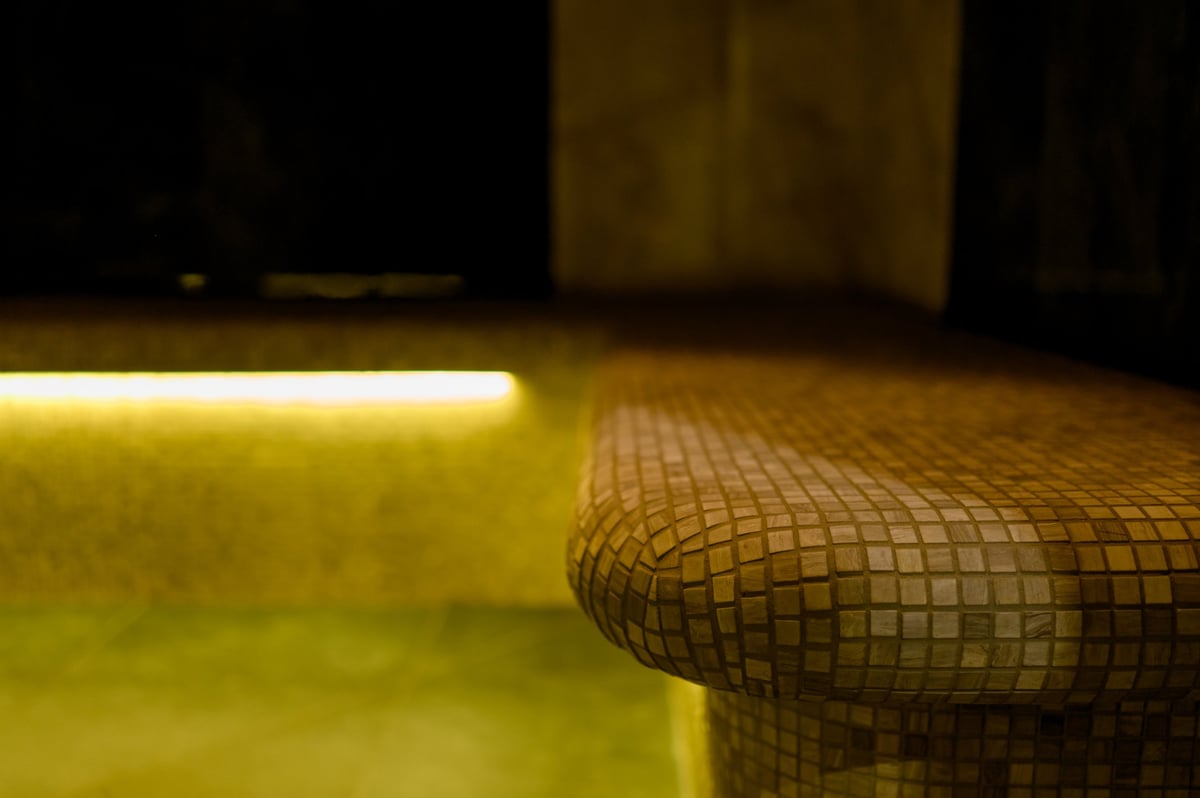 Hammam sauna with stone finishing and ambient lighting