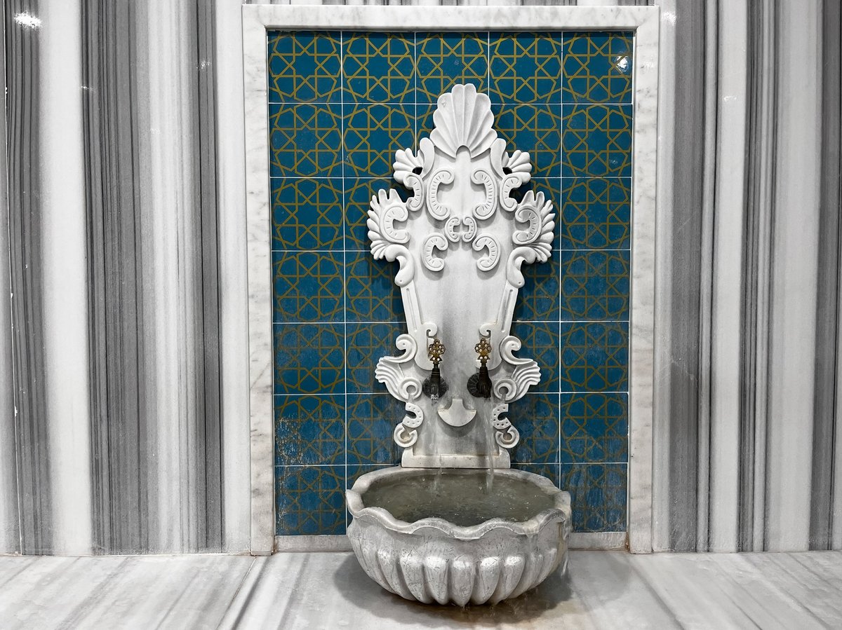 Traditional hammam stone fountain with gold details